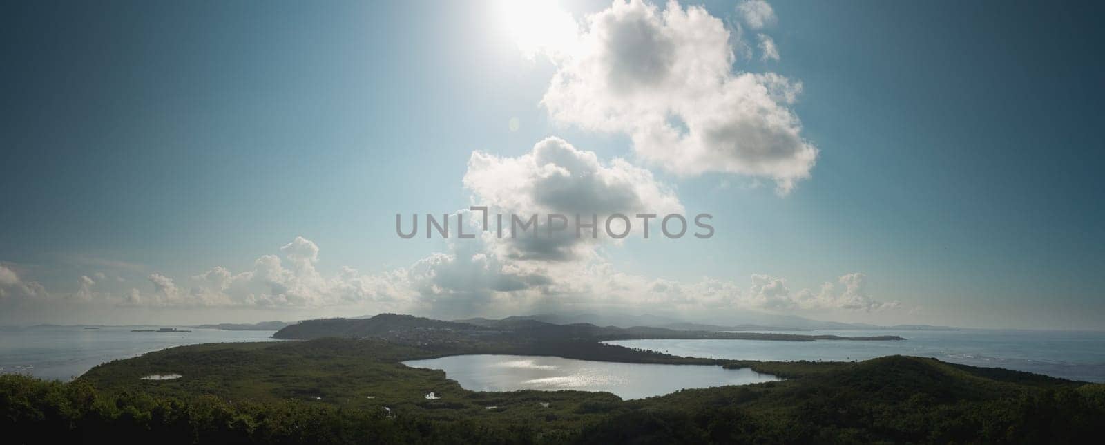 View across a lagoon towards El Yunque across with the distant rain falling on the rain forest