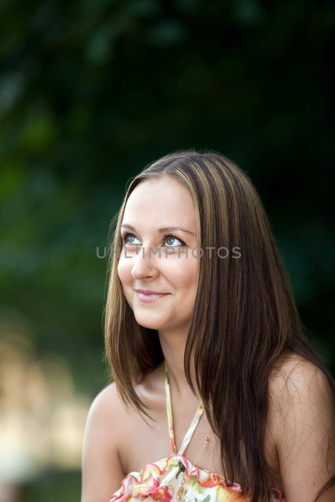 beautiful woman look up in park