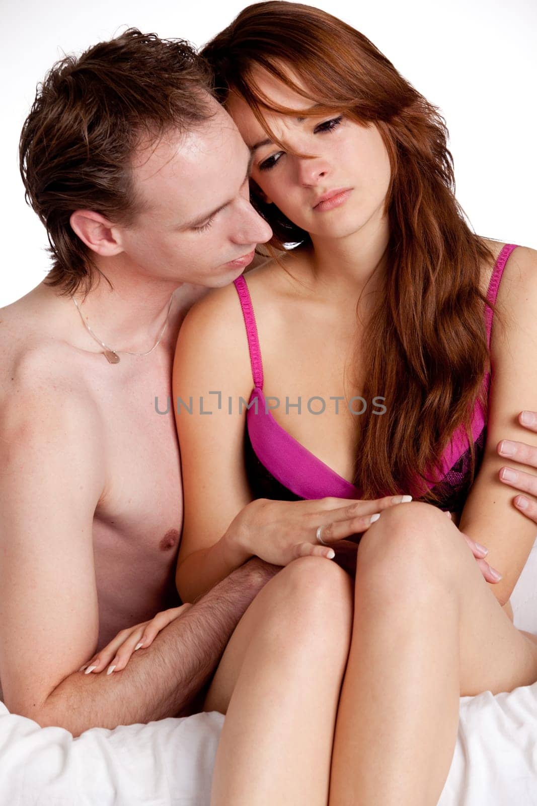 Young couple on a bed with emotions