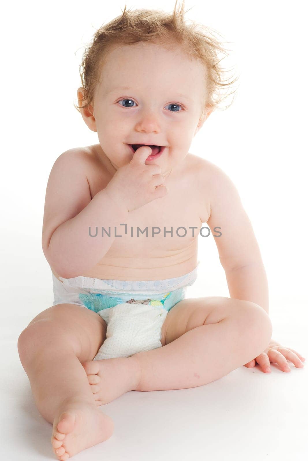 Cute baby in diaper playing on white