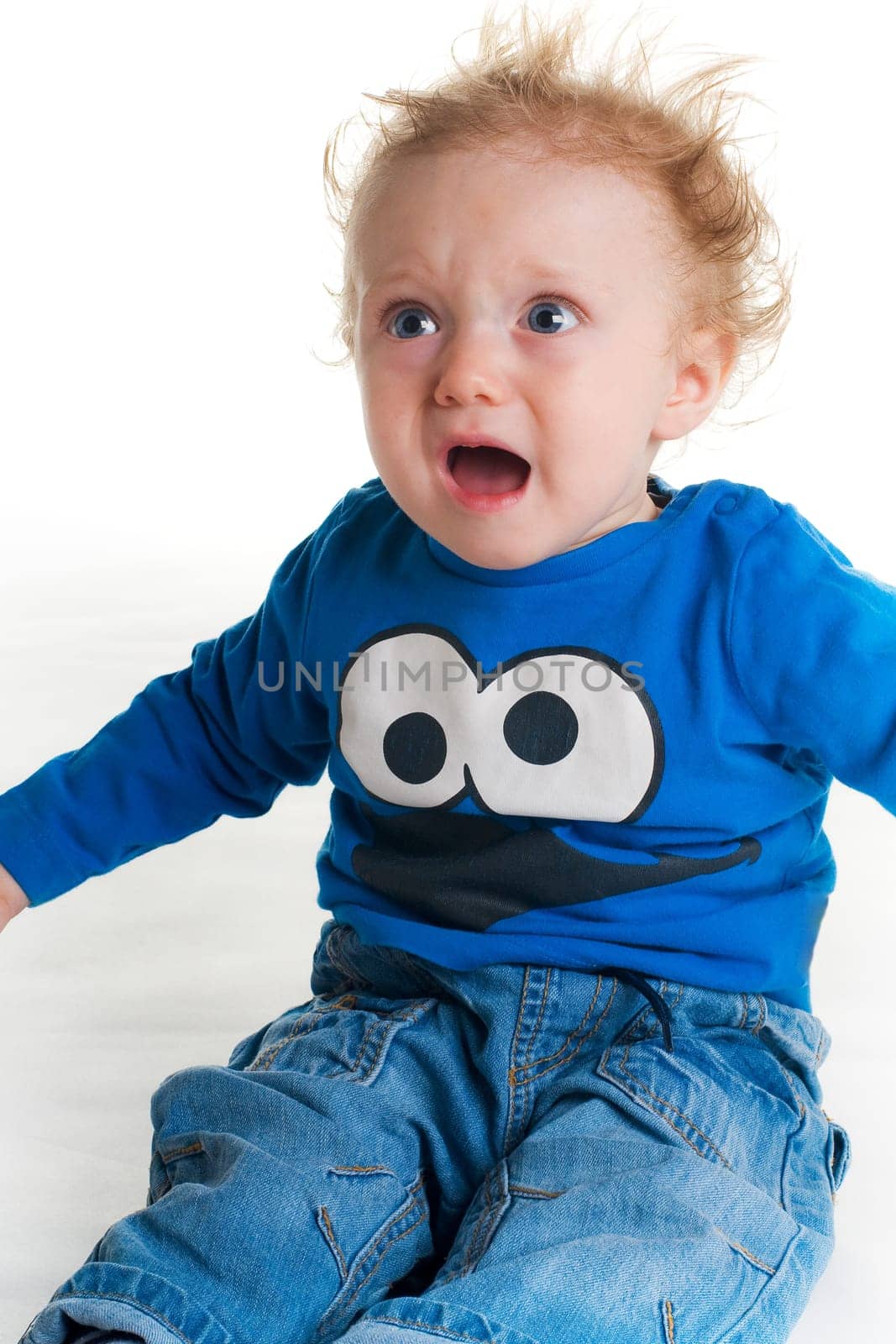 Crying sad baby with blue t-shirt