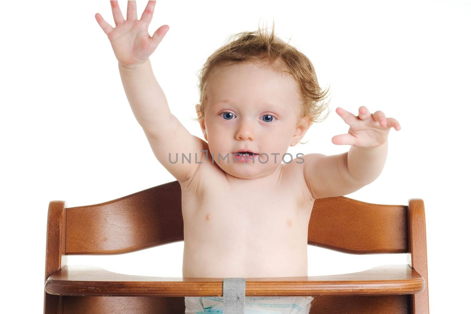 Cute hungry baby in dining chair with white background