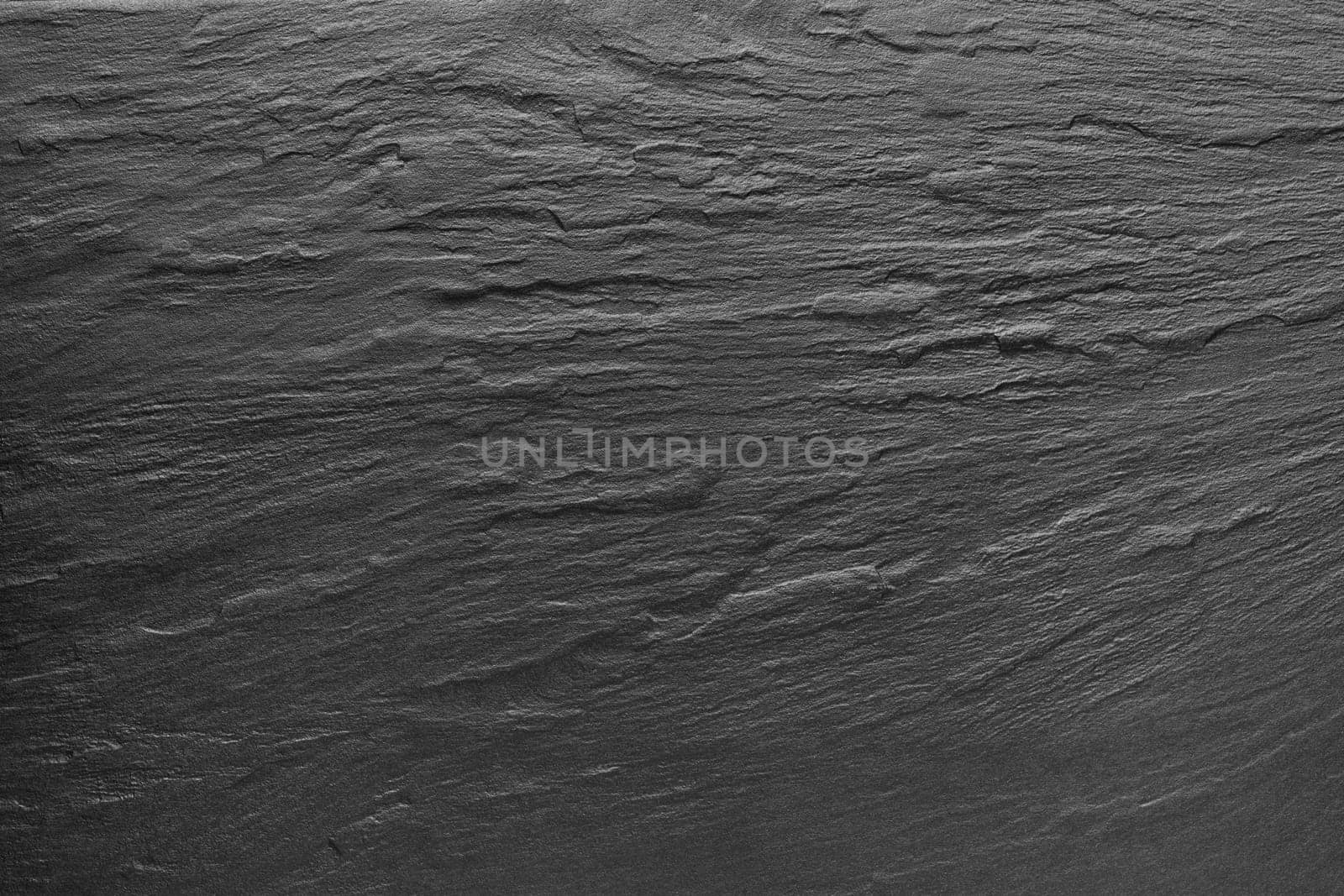Dark grey / black slate background or texture.