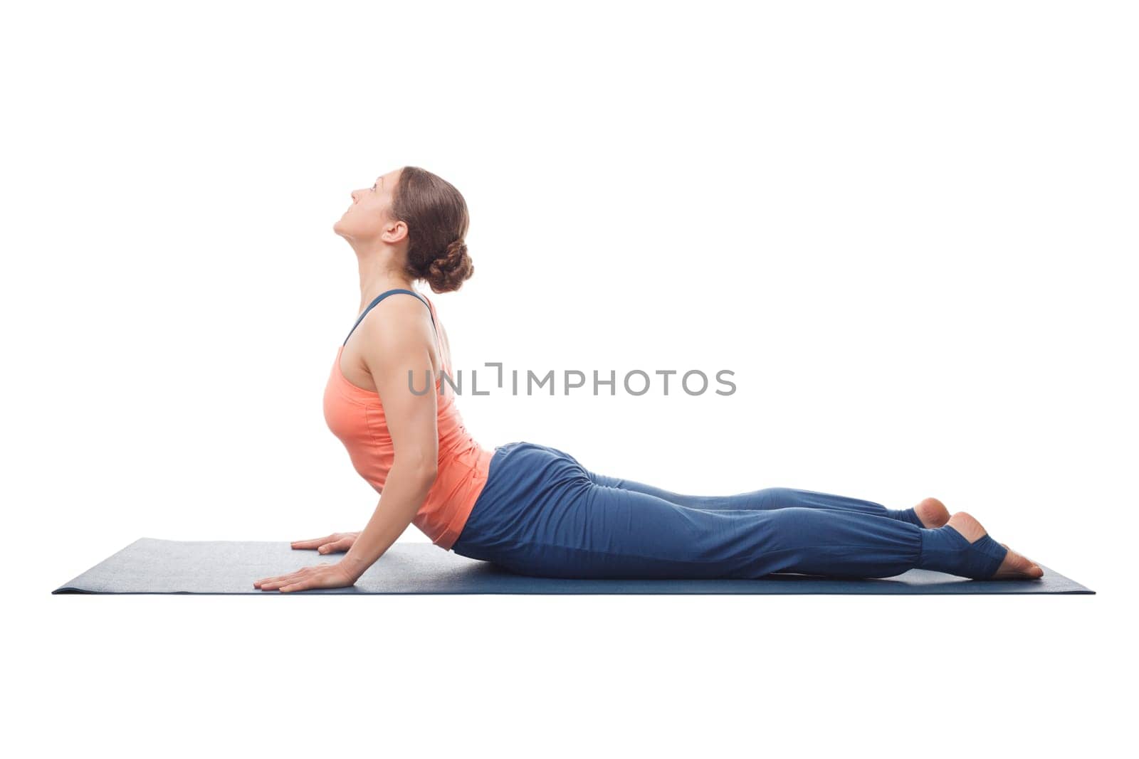 Beautiful sporty fit yogini woman practices yoga asana bhujangasana - cobra pose isolated on white background