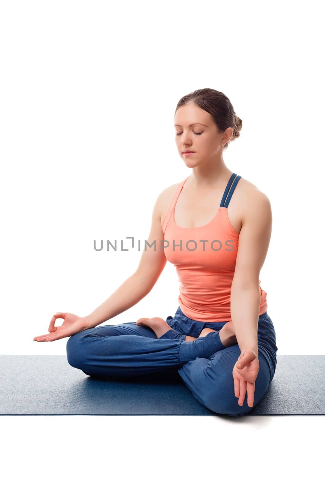 Fit yogini woman meditating in yoga asana Padmasana Lotus pose by dimol