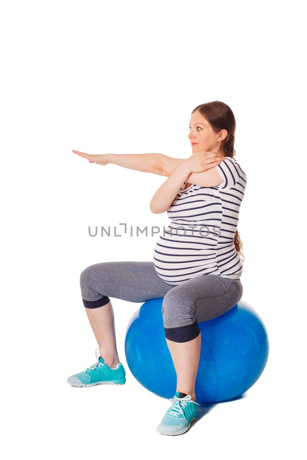 Pregnant woman doing exercises with exercise ball by dimol