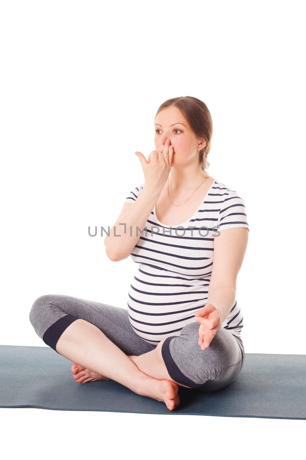 Pregnancy yoga exercise - pregnant woman doing yoga breathing exercise Pranayama isolated on white background