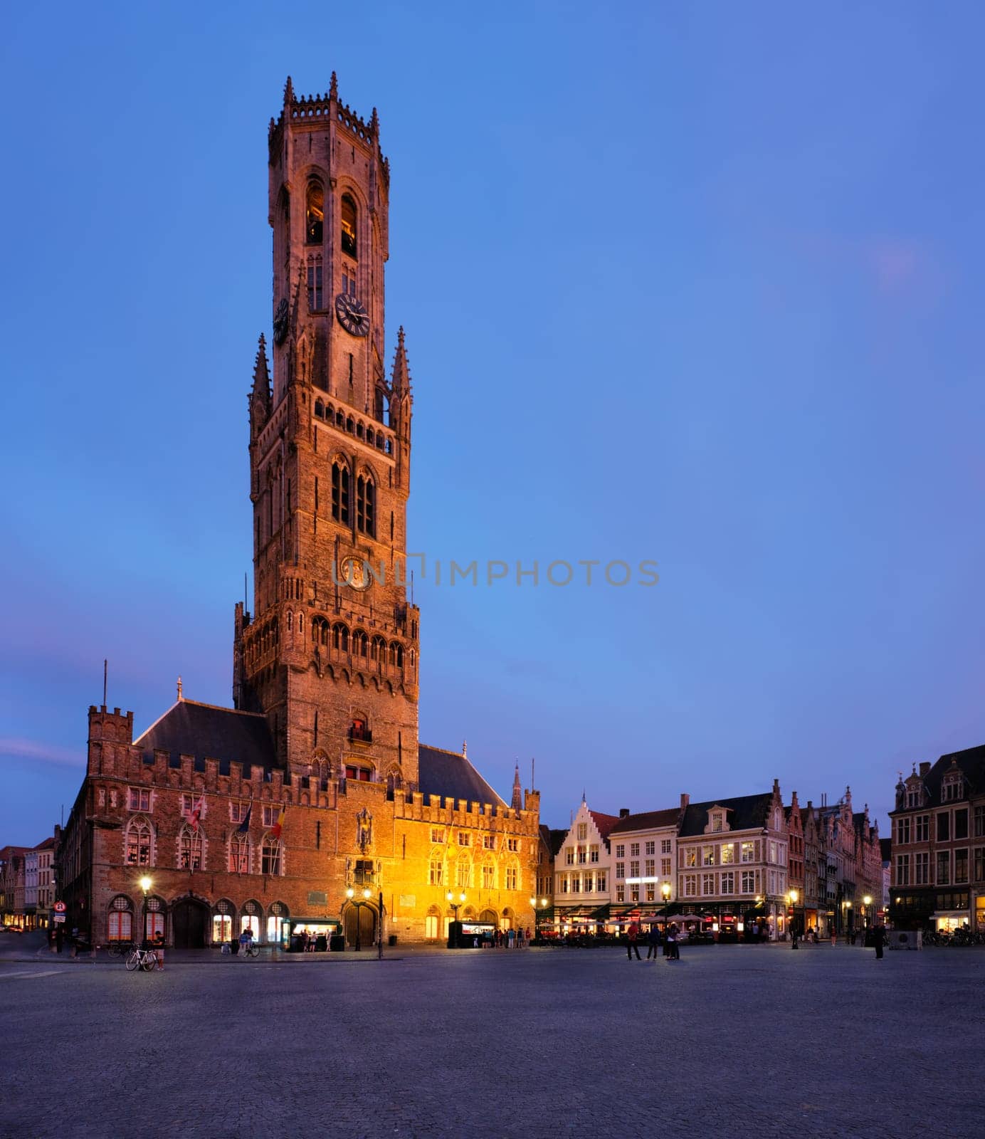 Belfry tower and Grote markt square in Bruges, Belgium on dusk in twilight by dimol