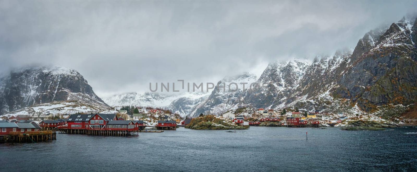 Panorama of traditional fishing village A on Lofoten Islands, Norway with red rorbu houses. With snow in winter