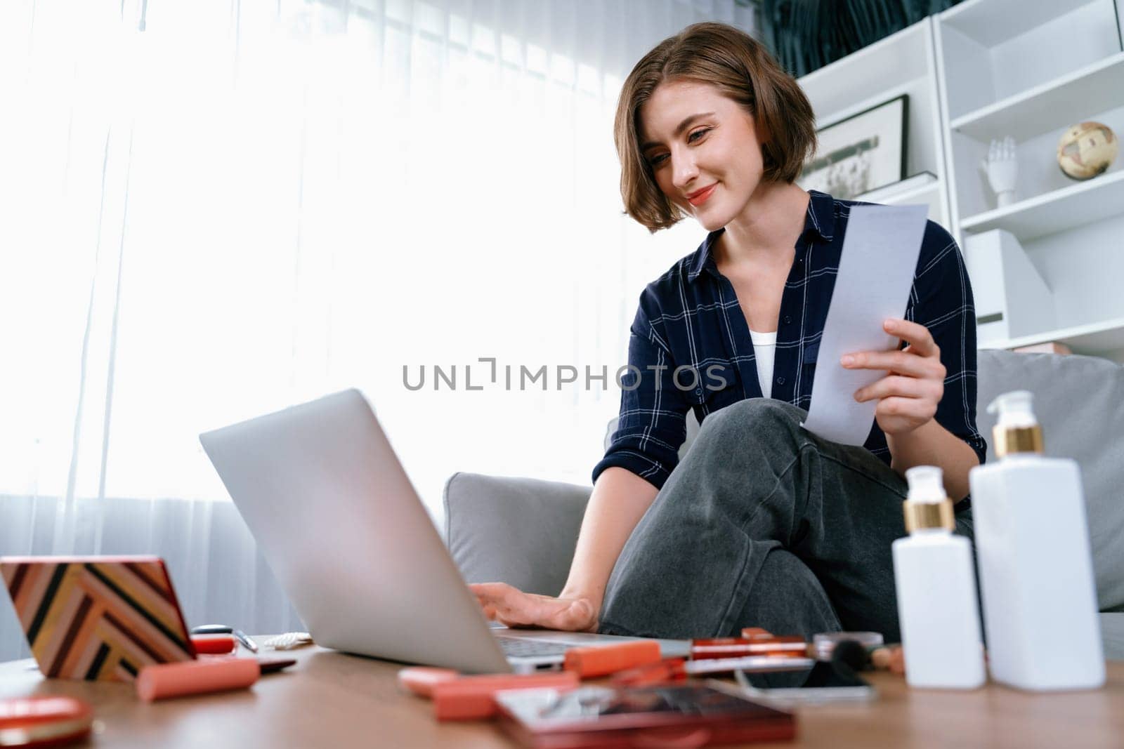 Young happy woman buy product by online shopping at home while ordering items from the internet with credit card online payment system protected by utmost cyber security from online store platform