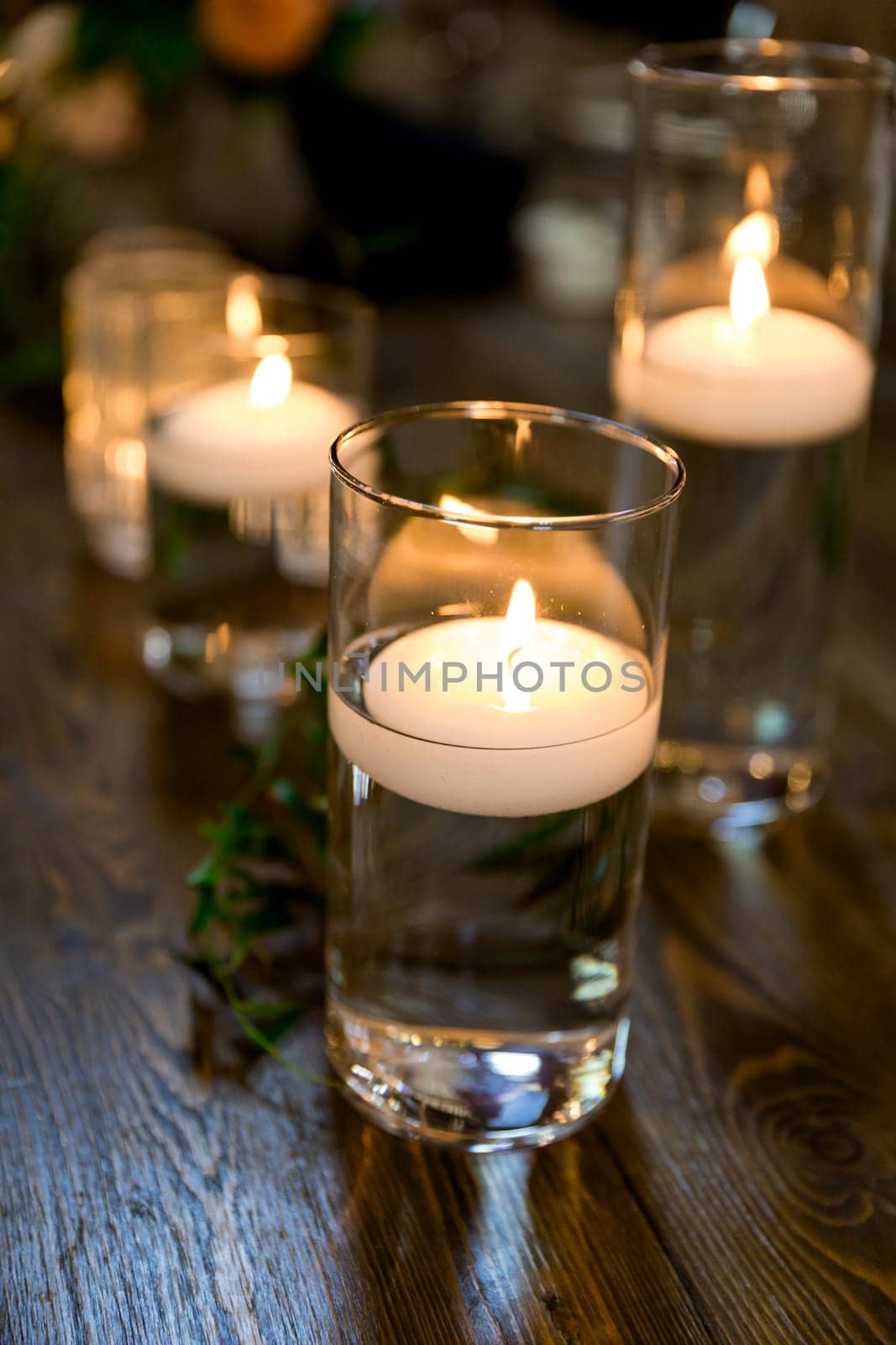 Candlelight Water Jars with Candles at Wedding by joshuaraineyphotography