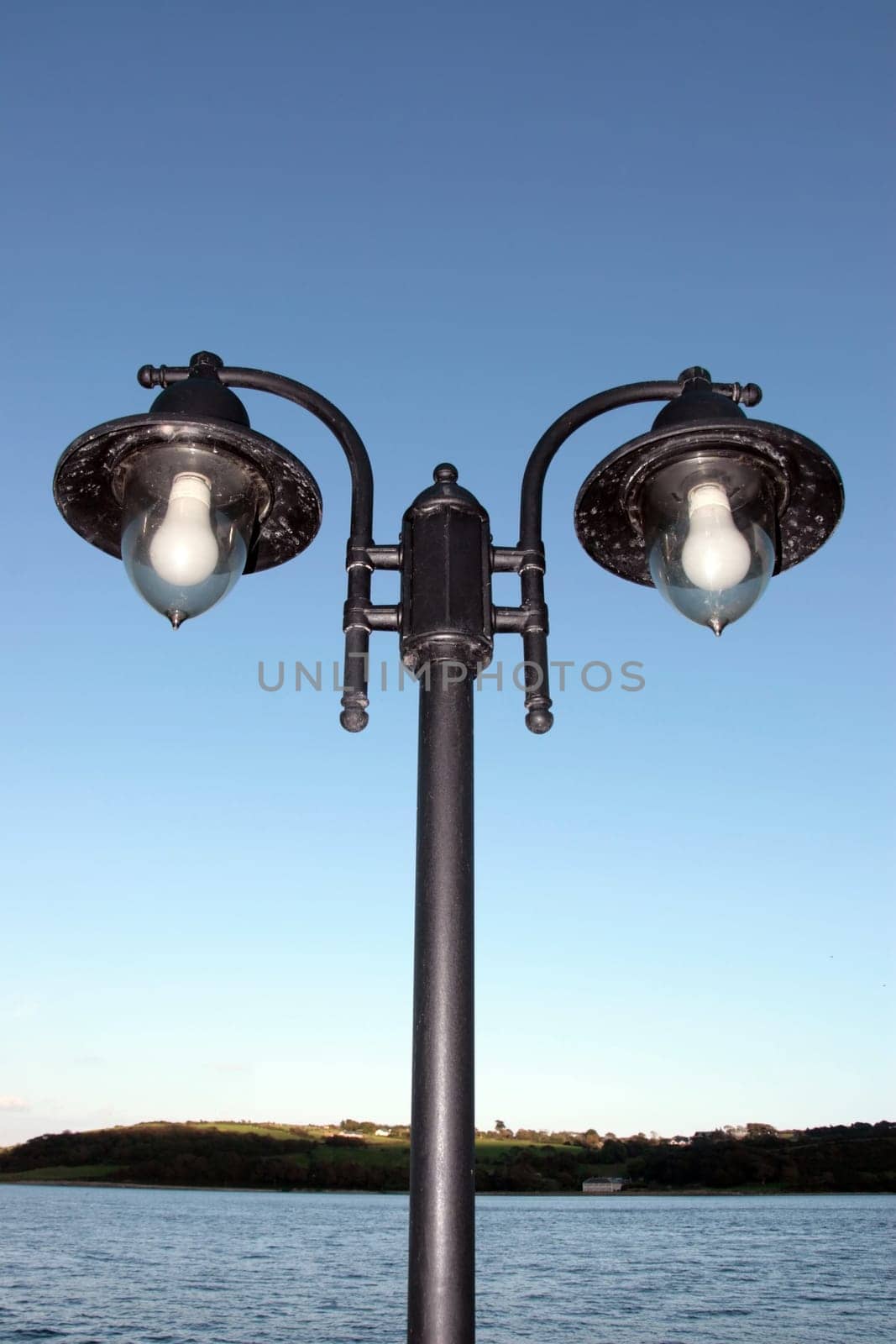 irish street light isolated on blue sky and sea background with clipping path