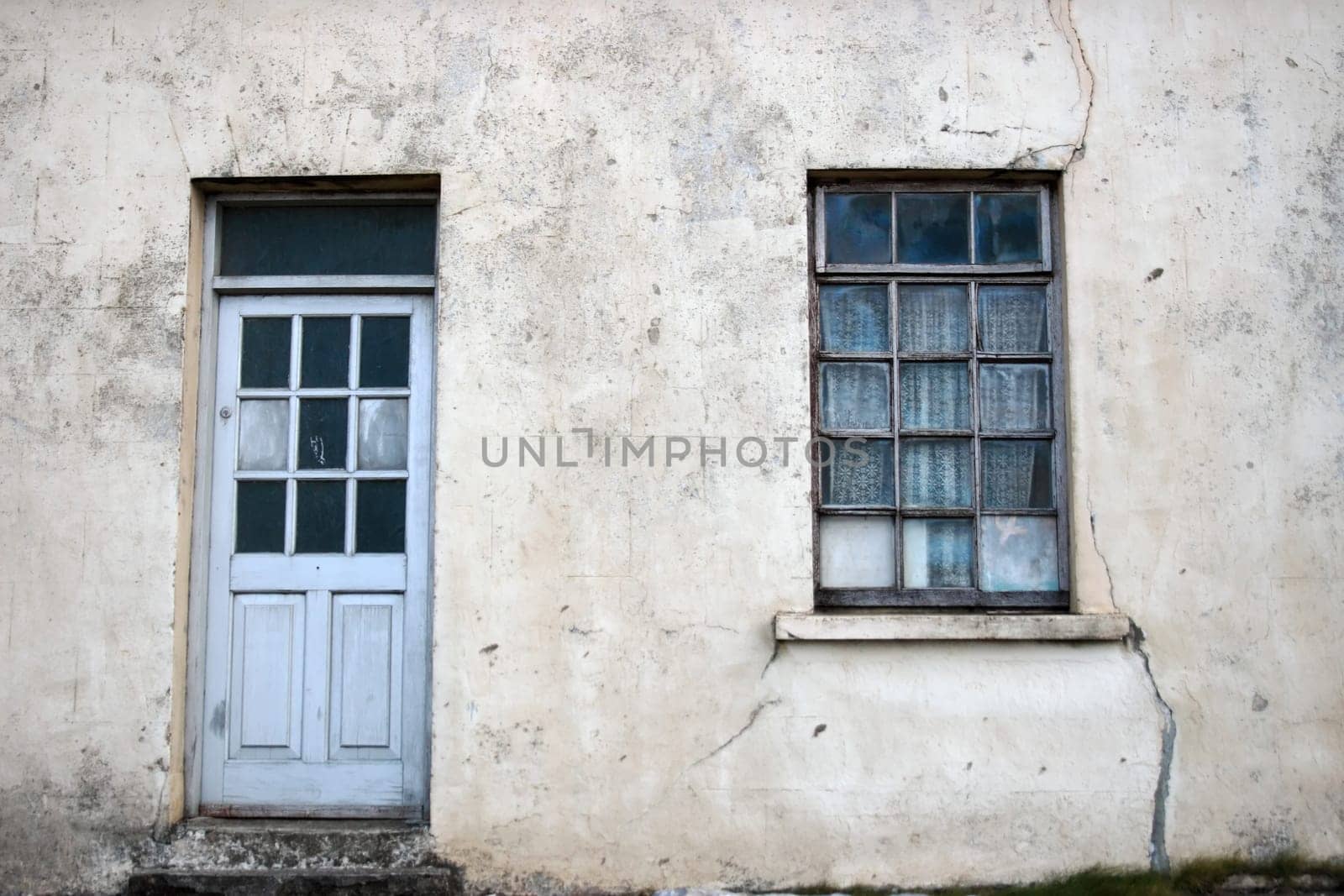 an old decaying house front door and window in ireland