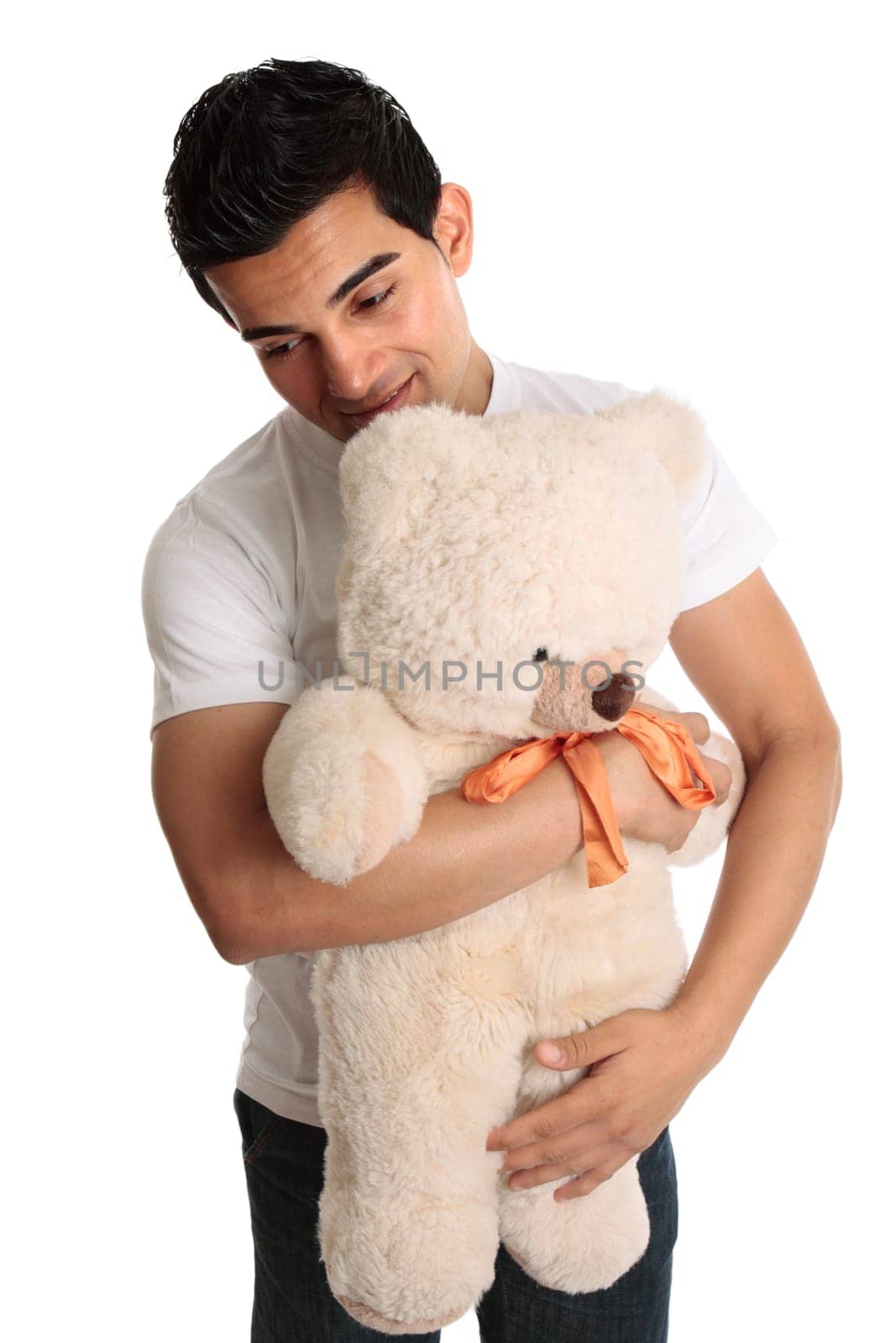 A man cuddling a teddy bear.  White background.