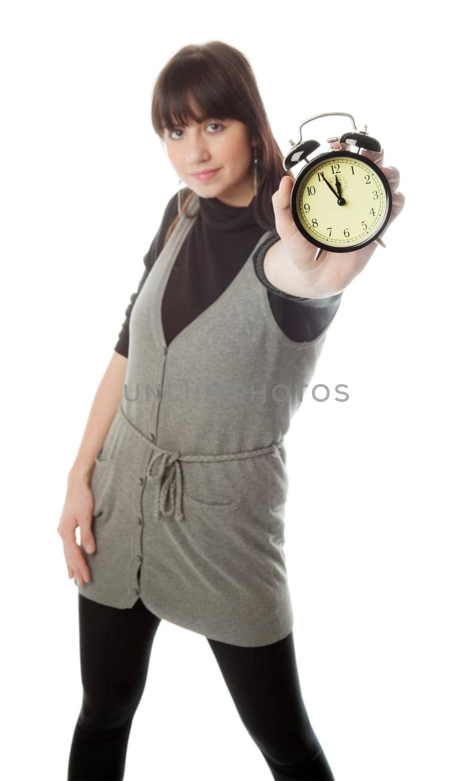Pretty brunette girl showing alarm clock  only clock is in focus