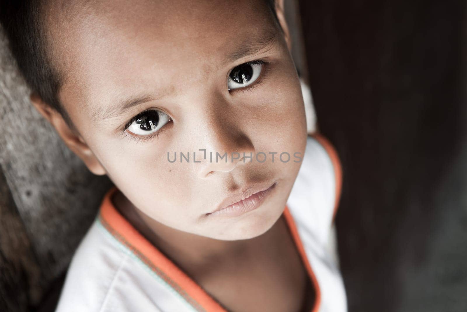 Portrait of a Filipino boy living in poverty - natural light - Manila, Philippines.