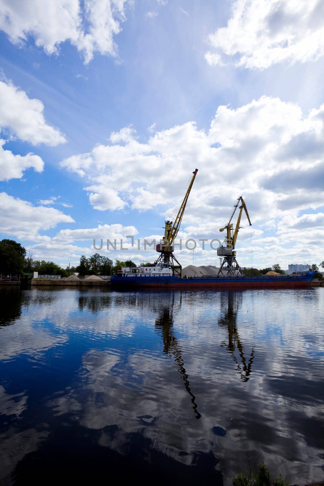 crane silhouette on dock and mirror river