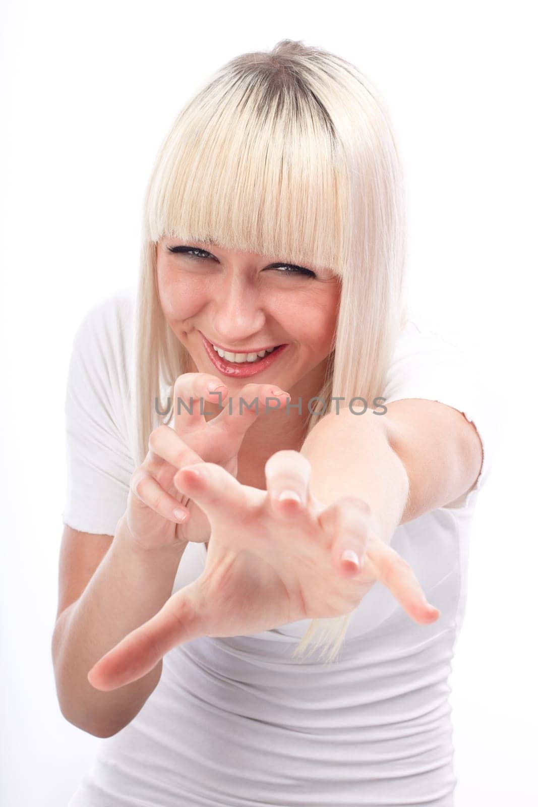 Portrait of excited young woman pointing with both hands towards the camera on white background