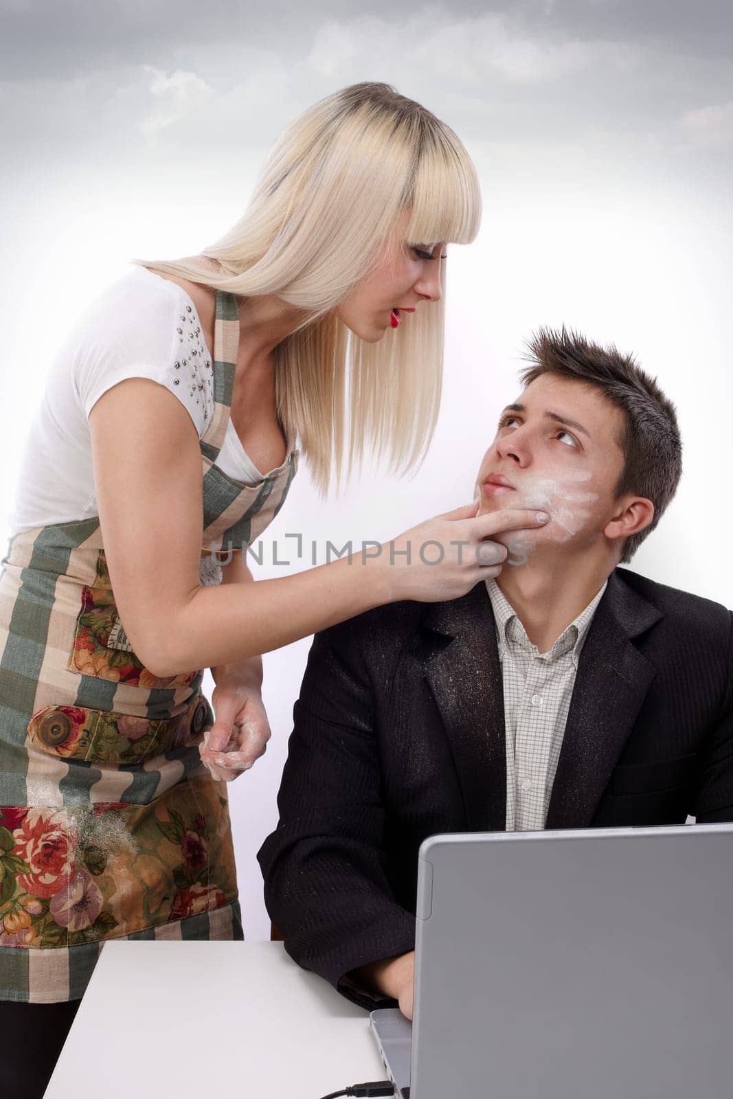 Young wife arguing with her husband because she&#039 s working and his sitting at the laptop