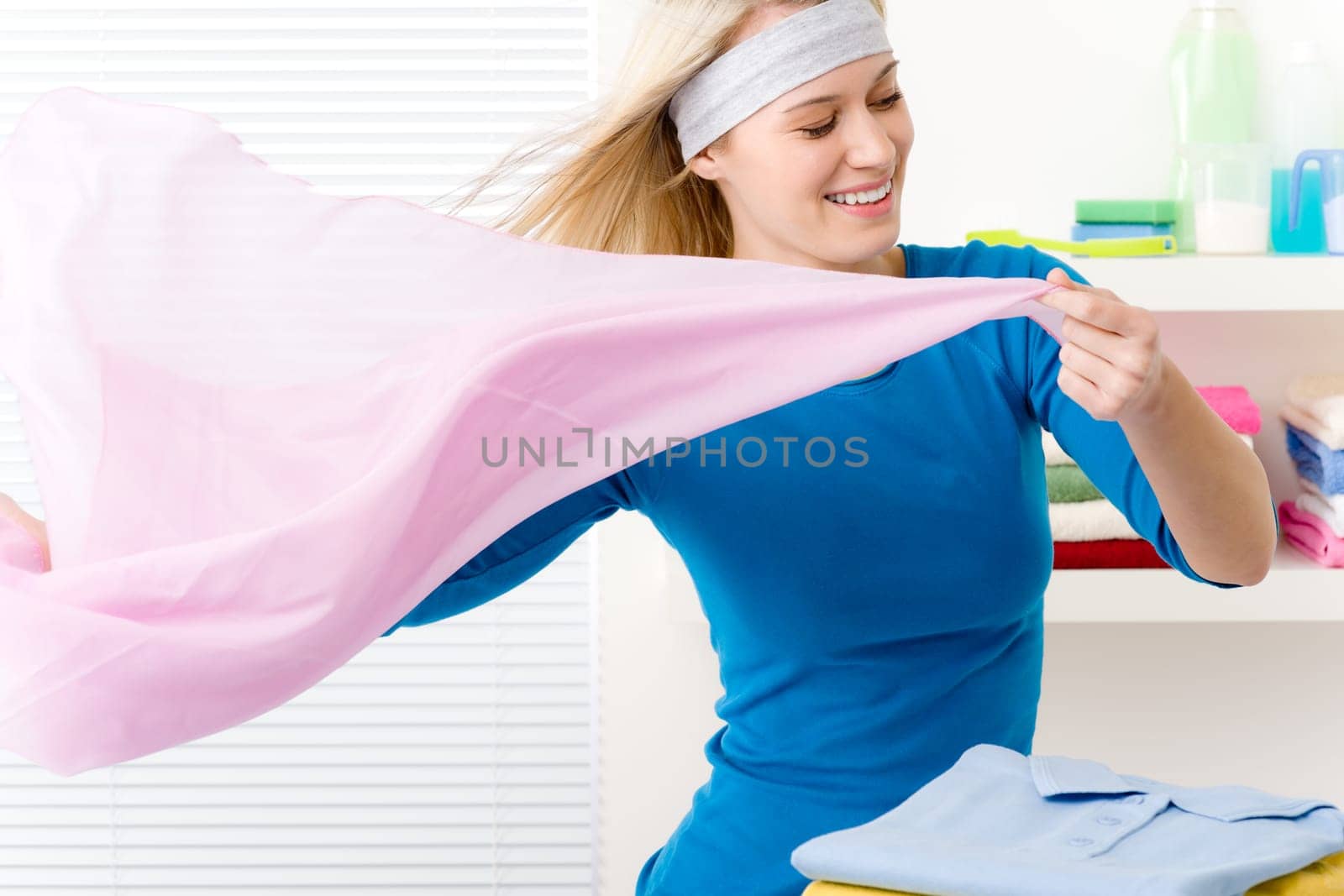 Laundry - woman folding clothes, housework