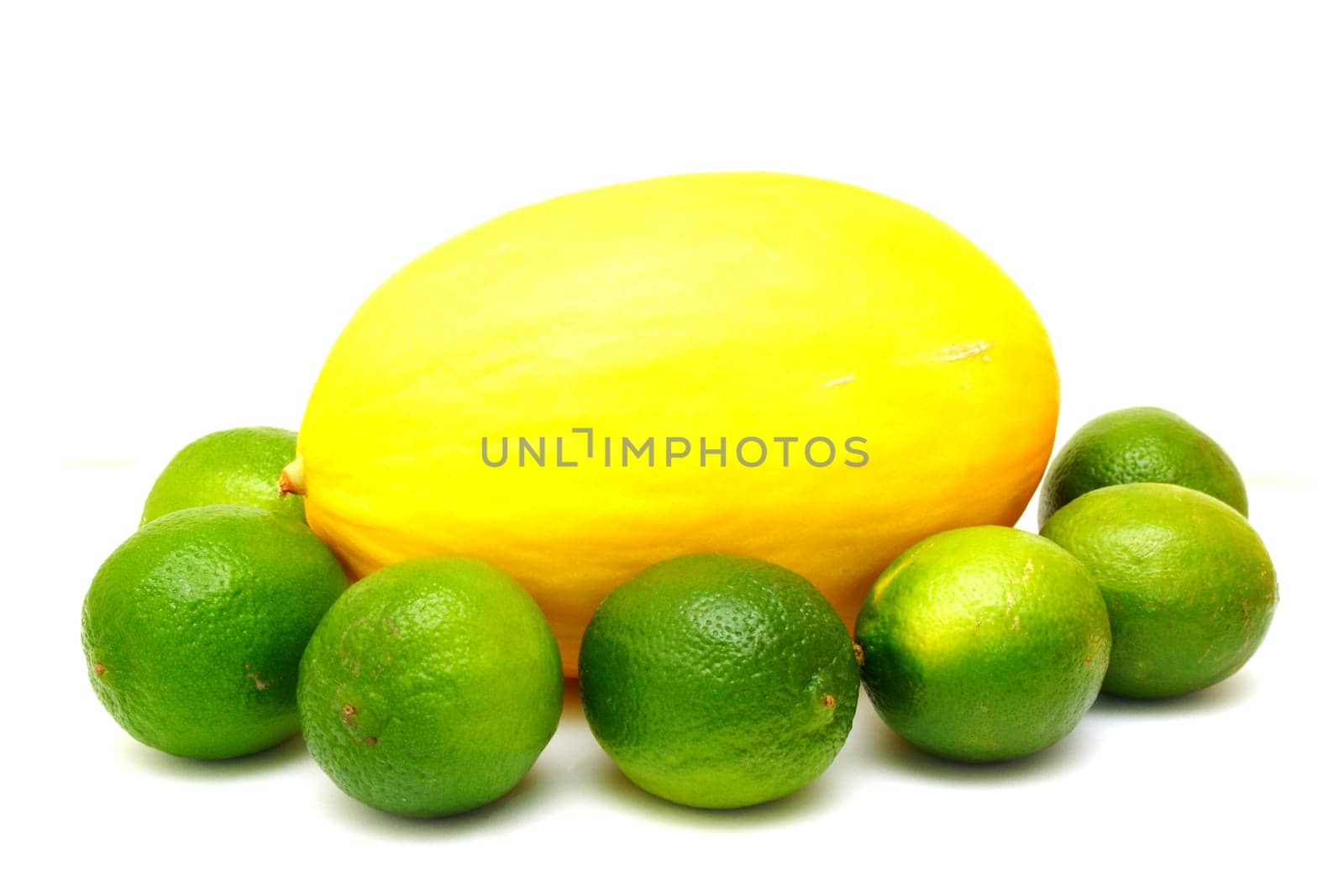Yellow melon with green laime isolated on white