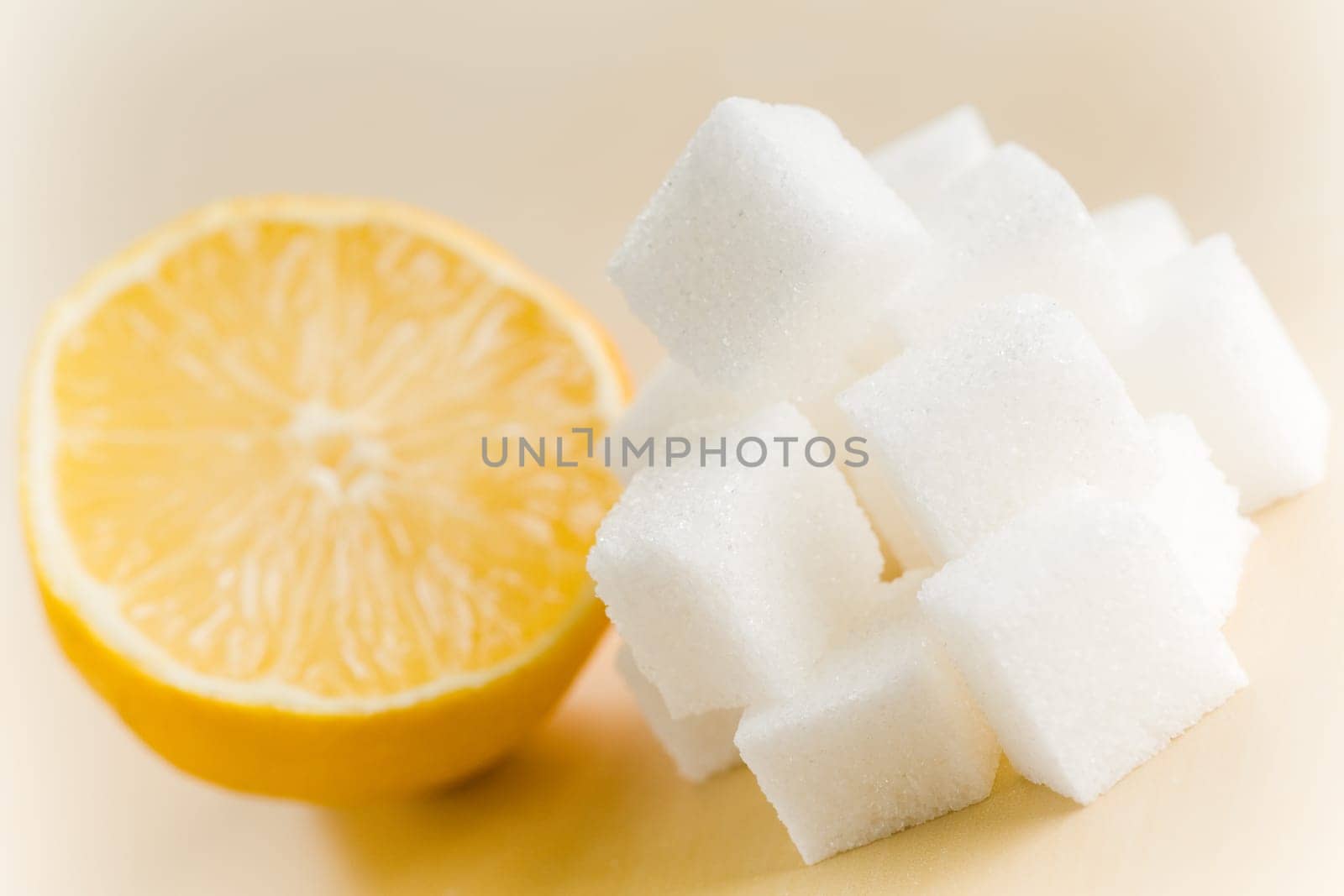 Fresh yellow lemon half with lots of sugar