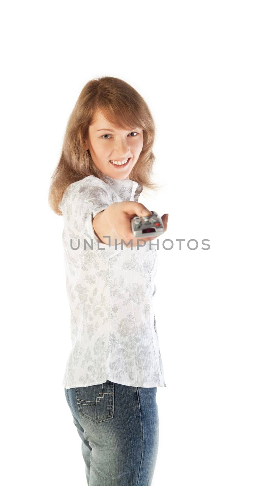 Pretty young blond woman aiming TV remote control  isolated on white