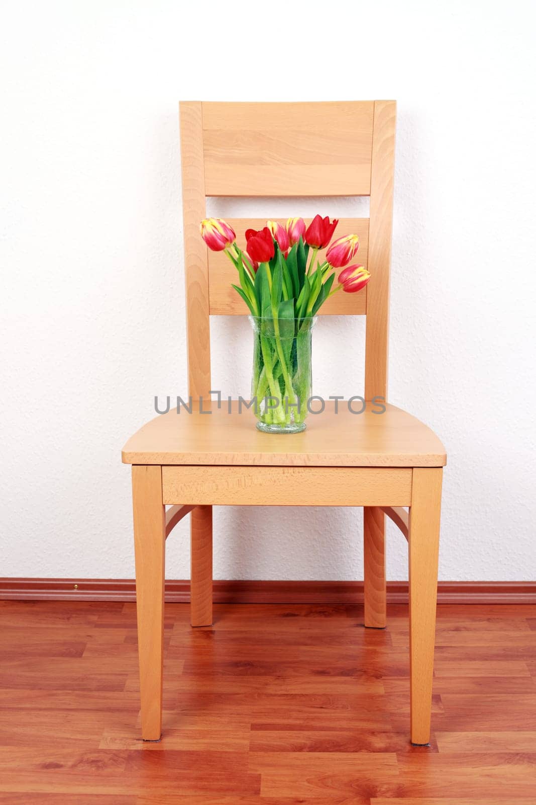 Chair with flowers by the wall