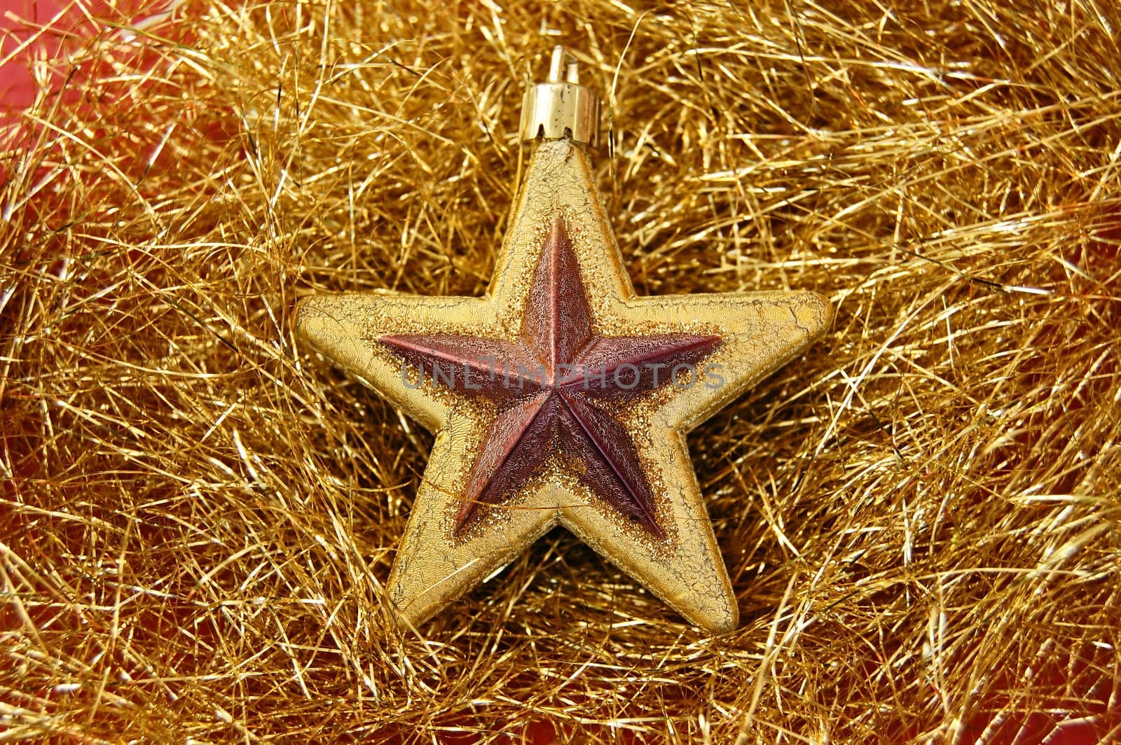 Christmas decorative star ornament on golden background.