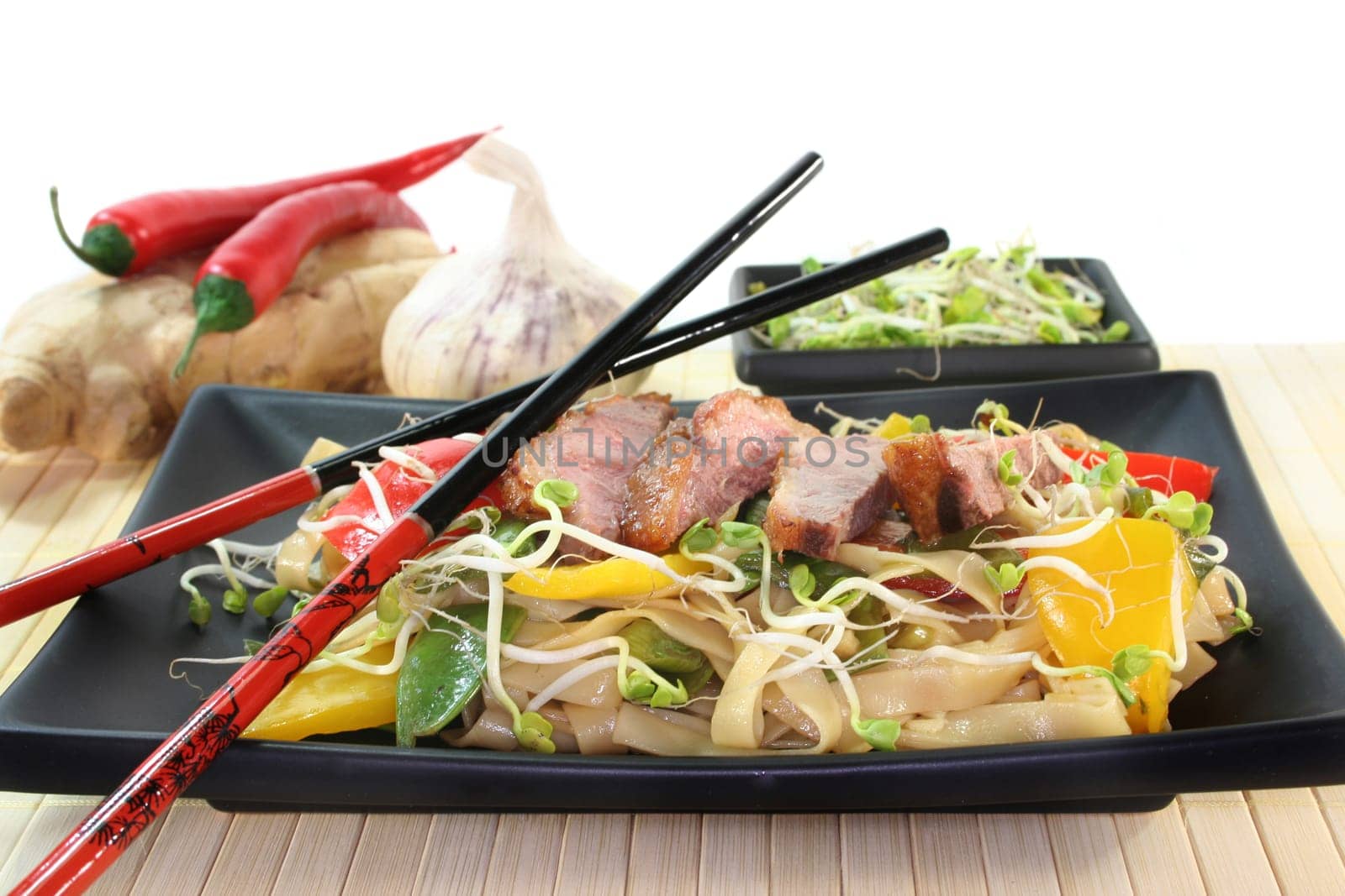 crispy duck breast with fried noodles and vegetables