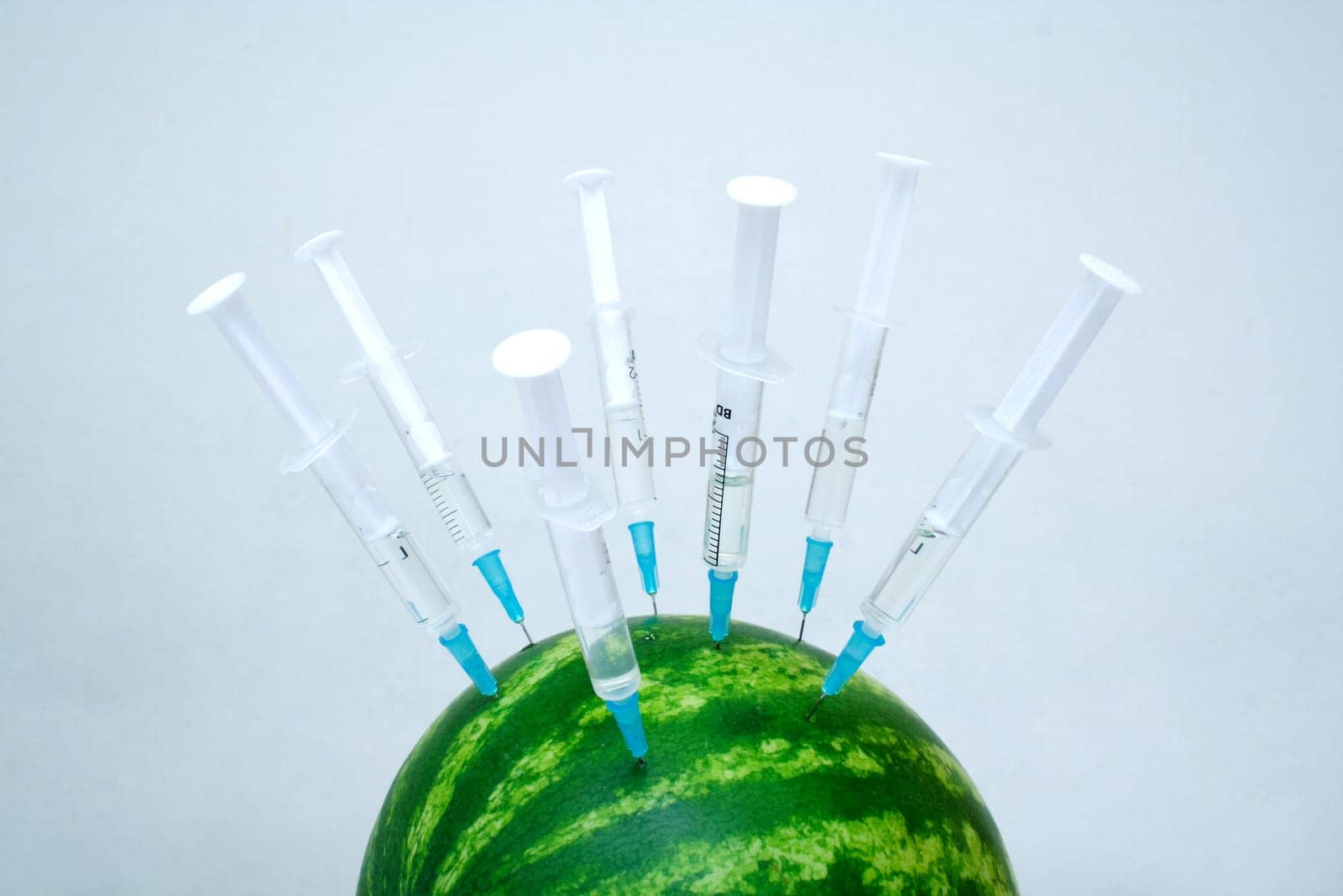 water melon with a lot of hypodermic syringes