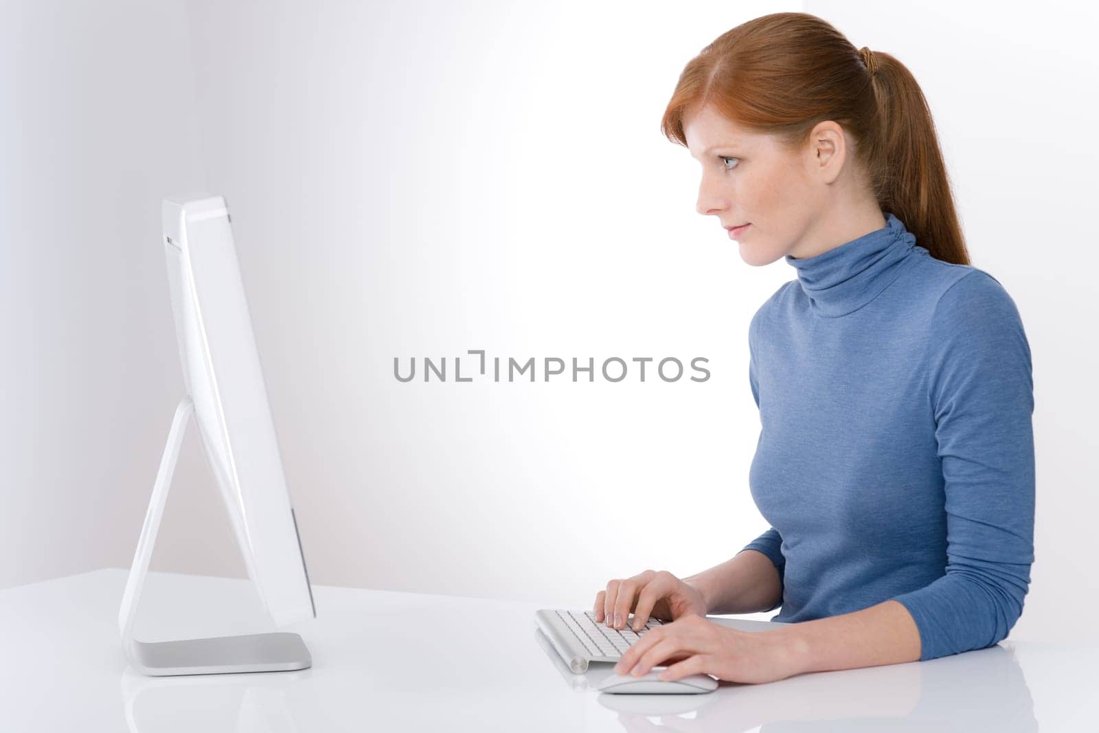 Modern office - young business woman work at computer