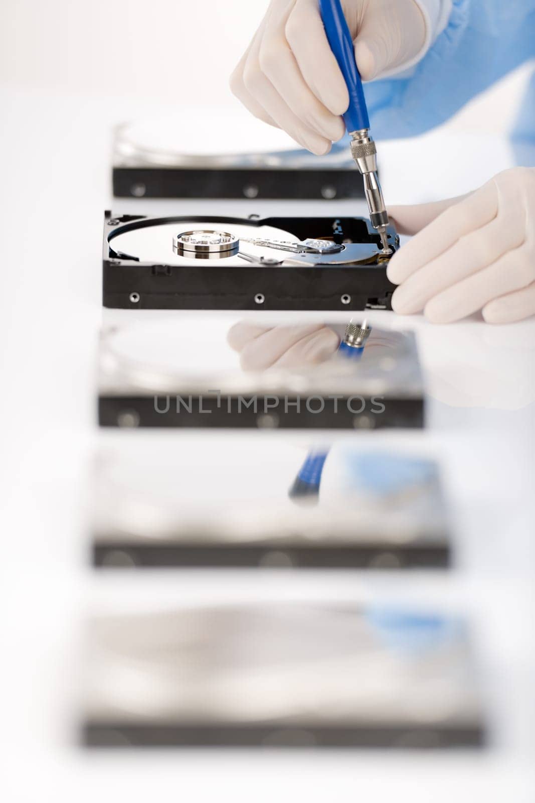 Computer engineer repair hard disc defect, experiment in sterile laboratory