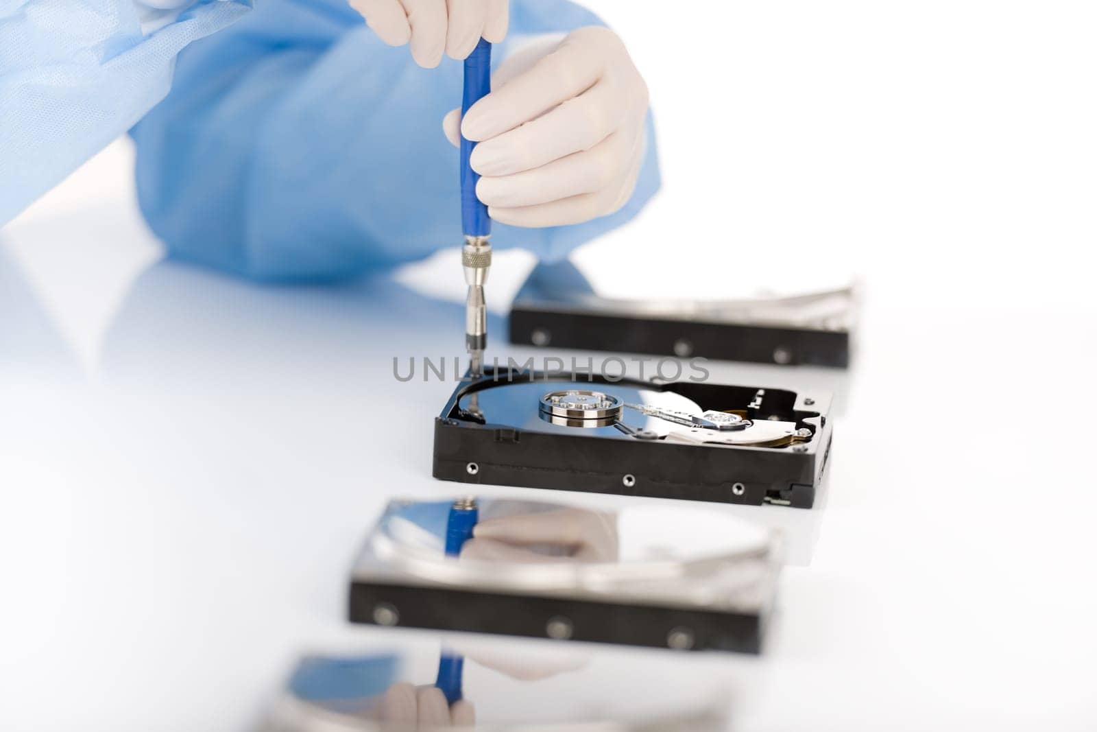 Computer engineer repair hard disc defect, experiment in sterile laboratory