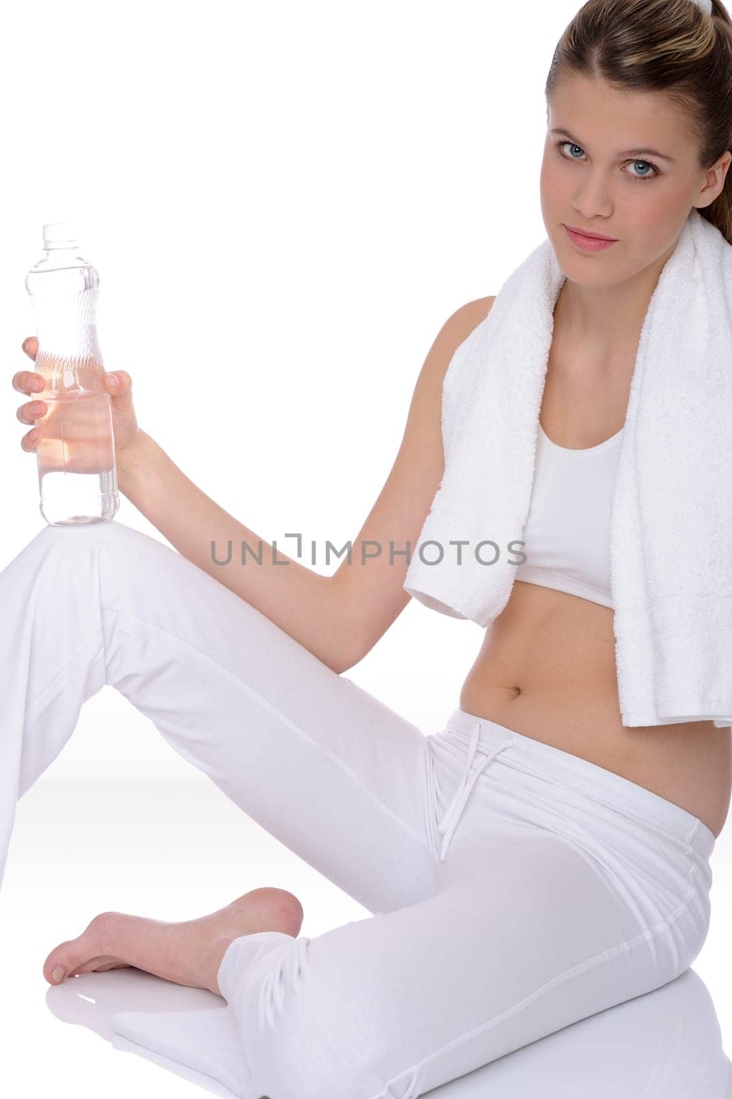 Fitness - Young sportive woman with water and towel on white background