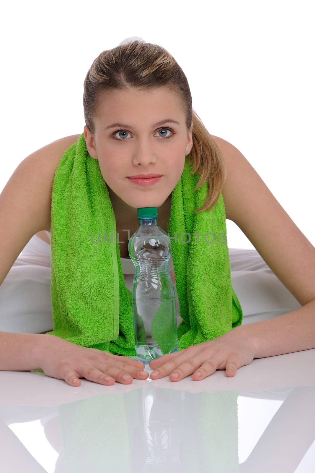 Fitness - Young sportive woman with water and towel on white background