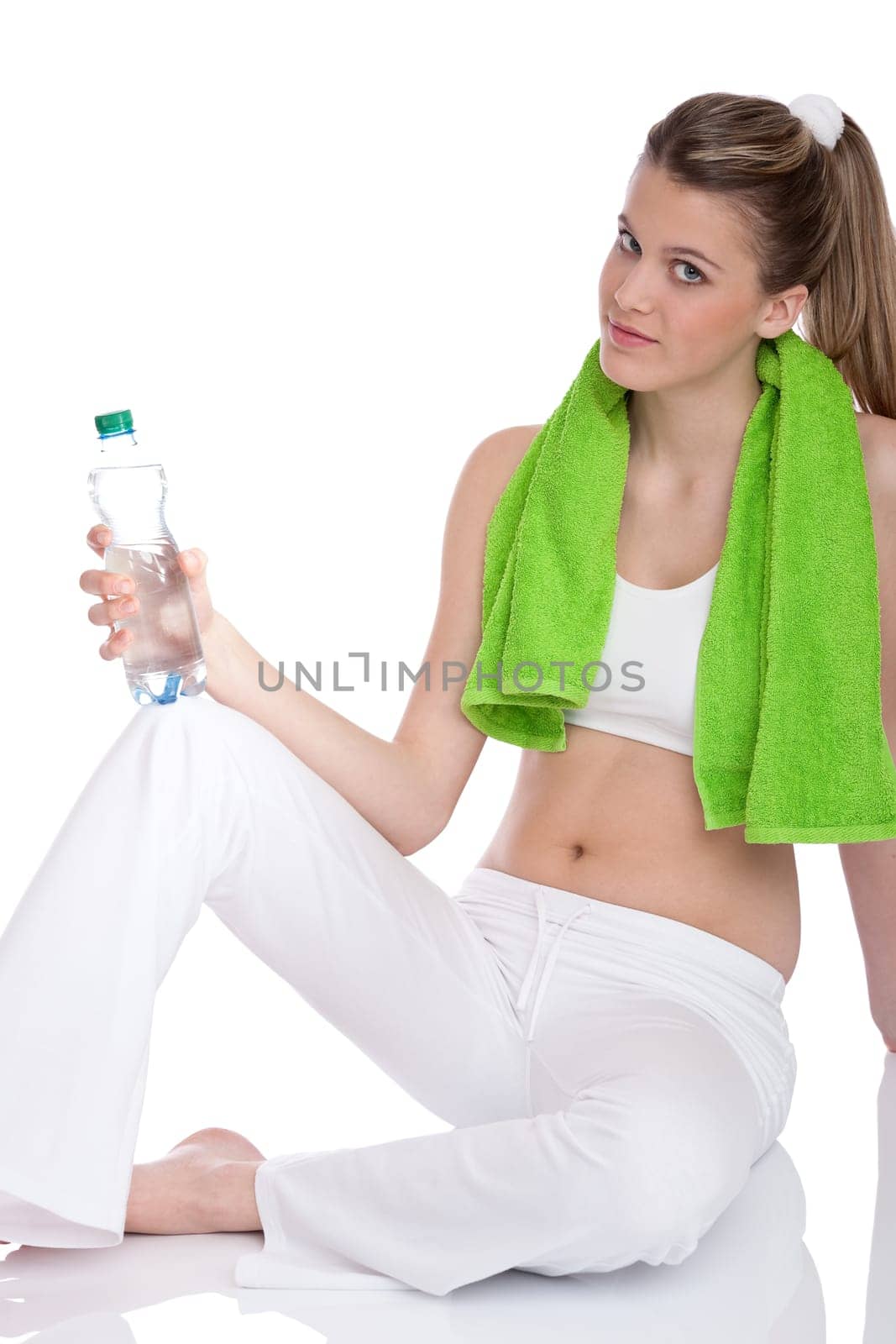 Fitness - Young sportive woman with water and towel on white background