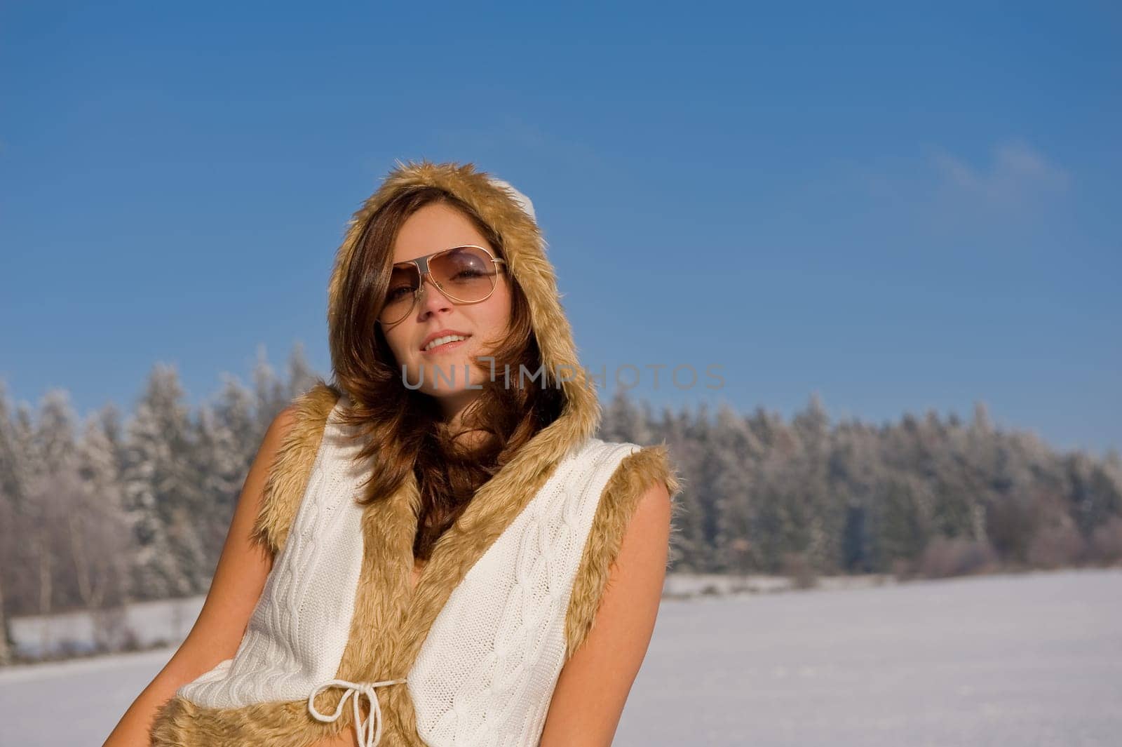 Attractive young woman with sunglasses in front of forest
