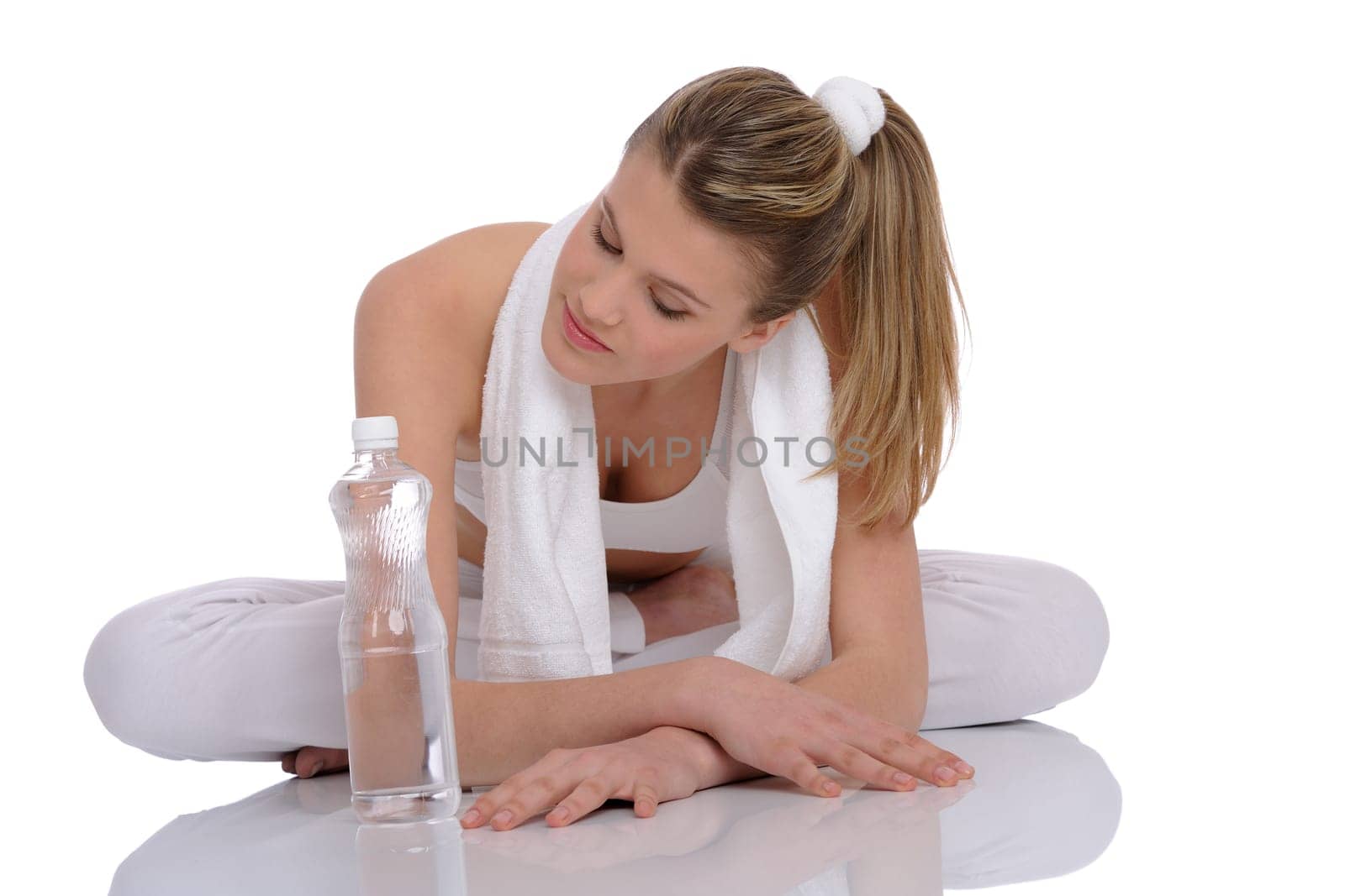 Fitness - Young sportive woman with water and towel on white background