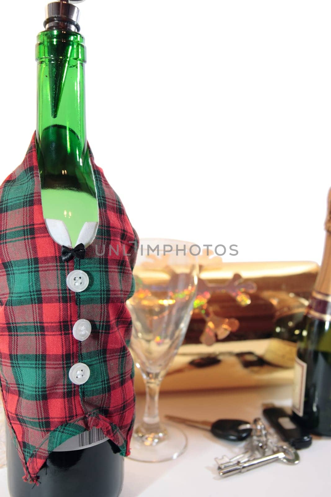 bottle dressed in jacket warmer with keys and alcohol on white background depicting drunk driving and addictions can kill