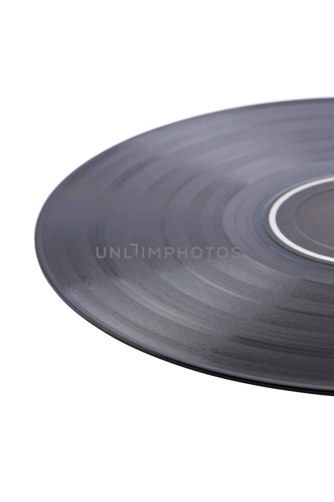 Dusty vinyl record with black label isolated on white background. Focus at front an very shallow depth of field