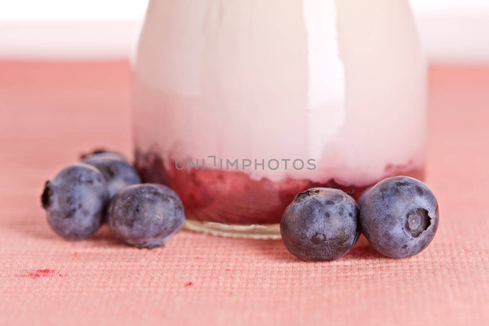 Delicious glass of yogurt and fresh blueberries. Shallow depth of field