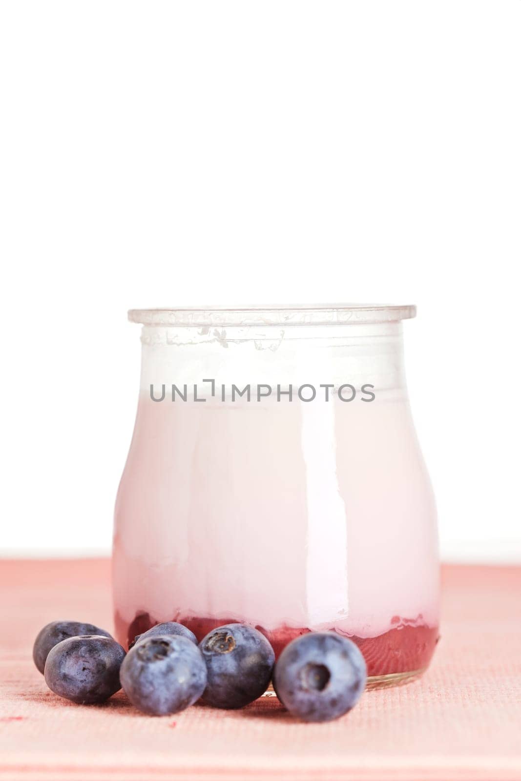 Delicious glass of yogurt and fresh blueberries. Shallow depth of field