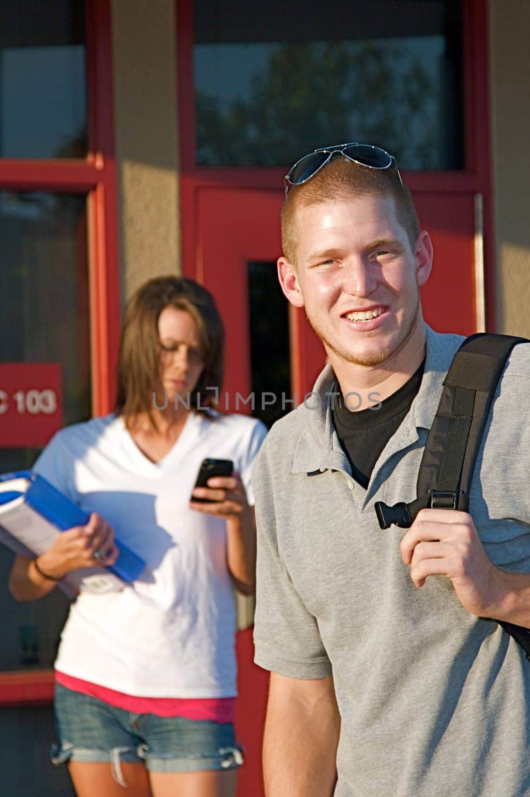 Young college students outside of a classroom at a public university