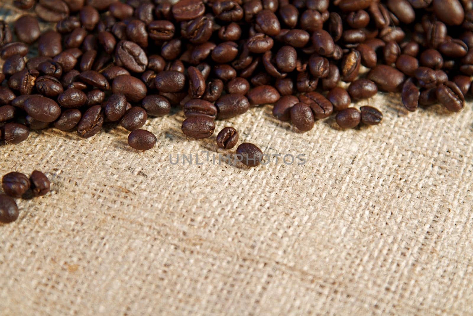 Coffee beans spilling from a burlap sack and fresh coffee