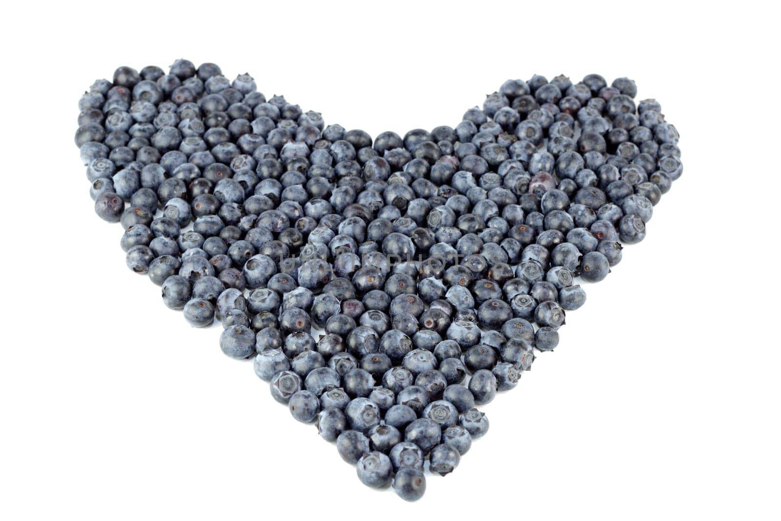 Natural blue purple fruit berry in the shape of large love on a white paper.