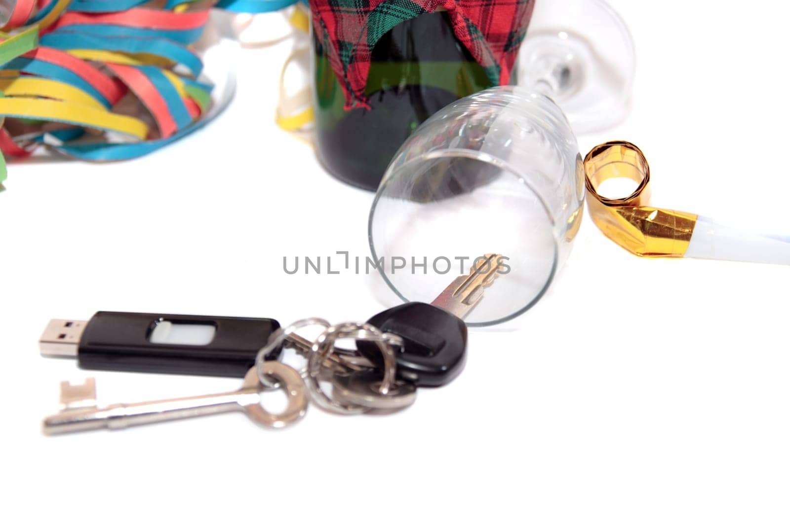 whiskey with keys inside fallen glass on white background depicting drunk driving and addictions can kill