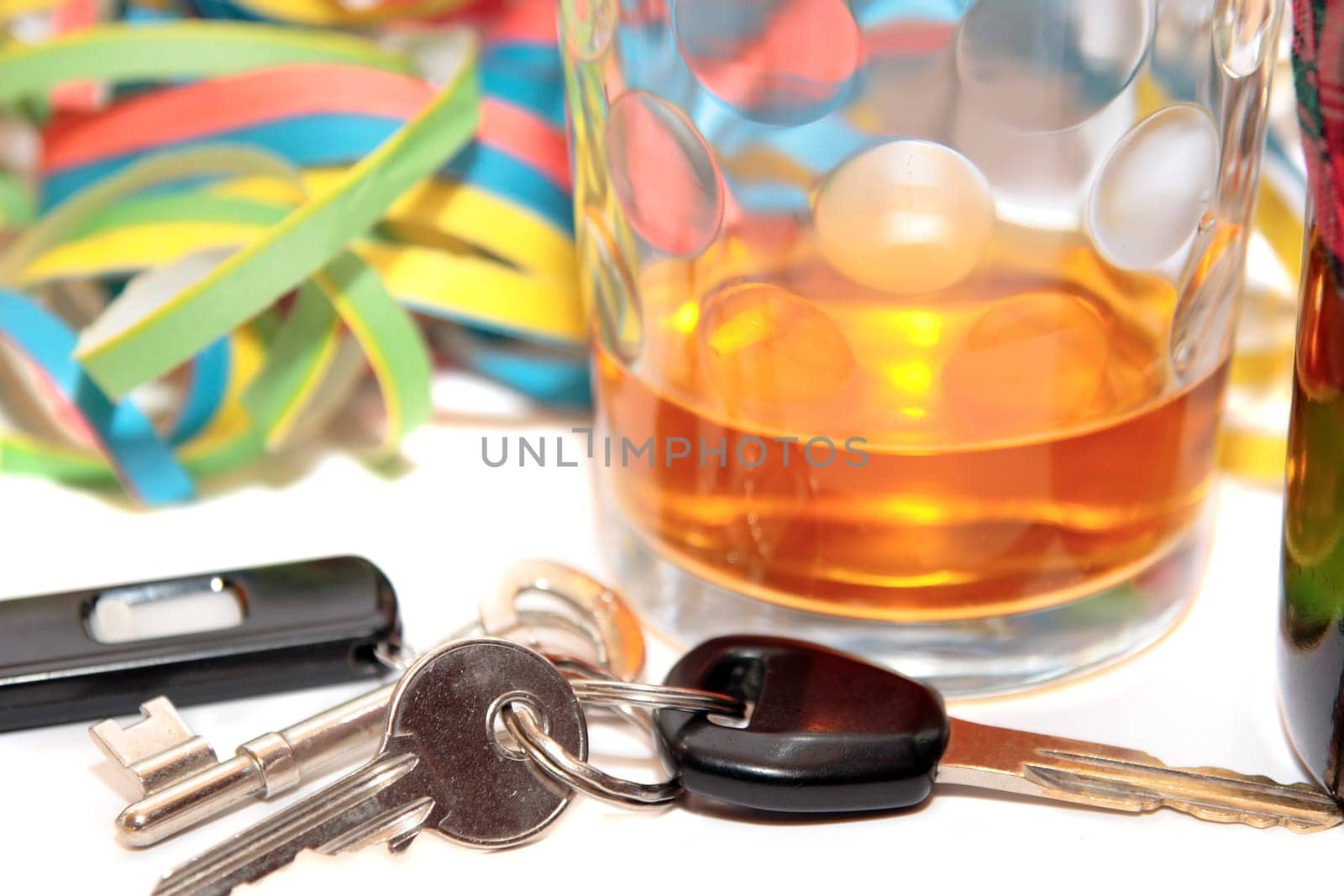 glass of whiskey and car keys on white background depicting drunk driving and addictions can kill