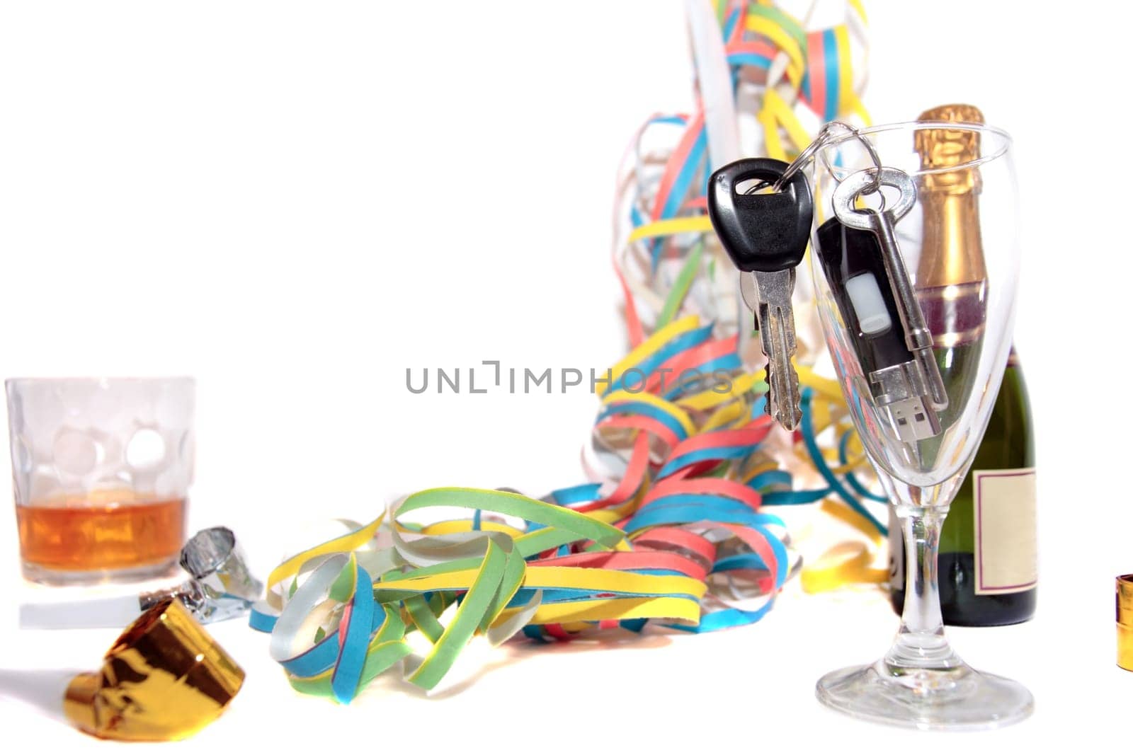 champagne glass and whiskey with keys in glass on white background depicting drunk driving and addictions can kill