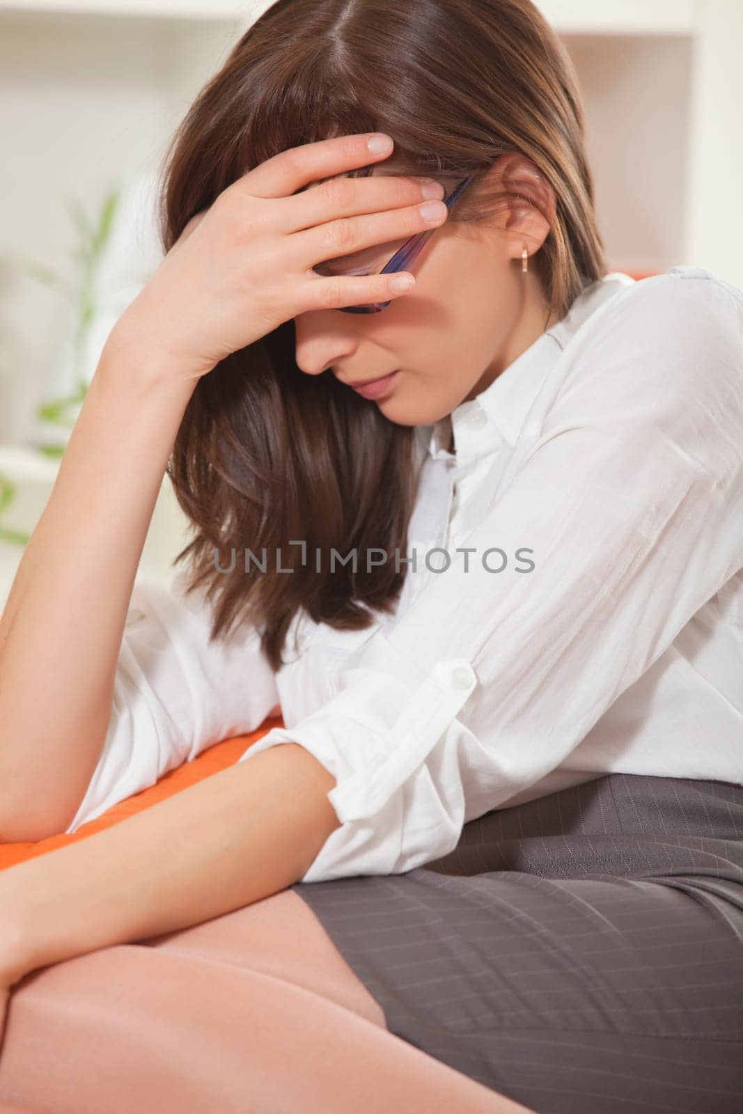businesswoman in stress with headache on the sofa